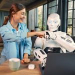 Robot and woman working on laptop in office