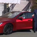 President Donald Trump getting out of the Tesla he purchased. He is accompanied by Tesla CEO Elon Musk.
