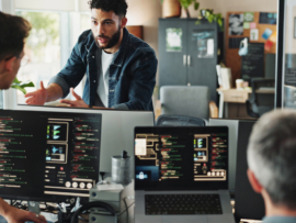 Men discussing about computer programming.