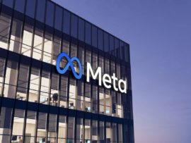 Meta signage on top of glass building.