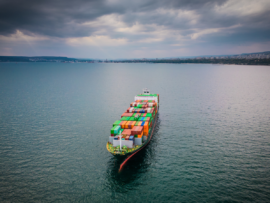 A loaded container ship in the sea, aerial view, concept of international trade and shipping
