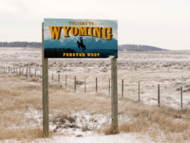 Welcome to Wyoming Forever West State entry sign.
